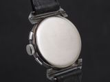 a close up of a watch on a black surface