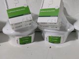 several containers of food sitting on top of a white counter