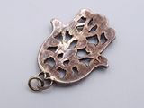 silver plated pendant with a fish design on a white background