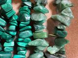 a close up of a bunch of green beads on a table