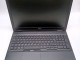 the laptop is open on a white surface with a black keyboard