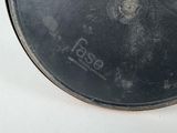 a black pan sitting on top of a white table