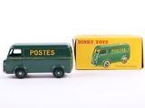 a green toy truck that is next to a box of postes