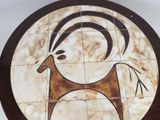 a picture of a tile with a picture of a goat on it