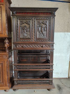 a wooden cabinet with carvings on it in a room