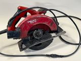 a picture of a red circular saw on a white surface
