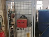 a metal cage with a fire hydrant inside of it