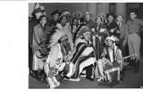 black and white photograph of a group of people dressed in native clothing