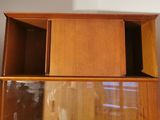 a wooden cabinet with a mirror on top of it