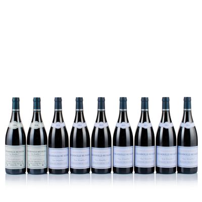 six bottles of wine lined up in a row on a white surface