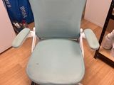 an image of a blue office chair in a room with a wooden floor