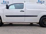 a small white van parked in front of a building