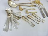 a lot of silver spoons and spoon spoons on a table