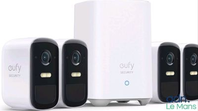 four smart home security cameras sitting next to each other on a white surface
