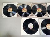 four black vinyl records sitting on top of a table next to each other