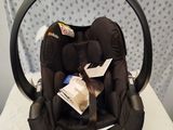 a baby car seat that is sitting on a chair