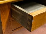 a wooden table with a drawer underneath it