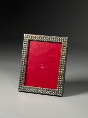 silver and red picture frame on a grey background