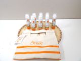 six bottles of perfume sitting on a basket with a bag