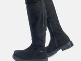 a close up view of a woman ' s legs wearing knee high boots