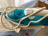 a blue and white steam iron sitting on top of a box