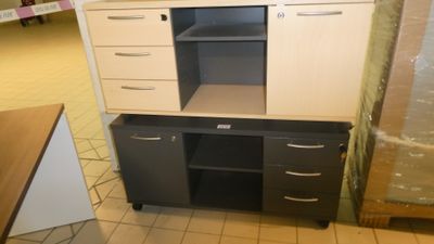 a kitchen cabinet with drawers and a microwave on it