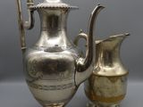 an antique silver plated coffee pot and a silver plated pitcher