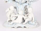porcelain figurine of a group of cherensils under a tree