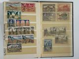 an open book with stamps on it on a table