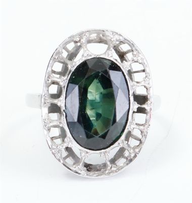 an image of a green tourmaline and diamond ring on a white background