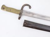 a knife that is laying next to a knife on a table