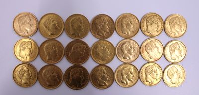 a lot of gold coins on a white surface