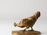 bronze figurine of a pheasant on a white background