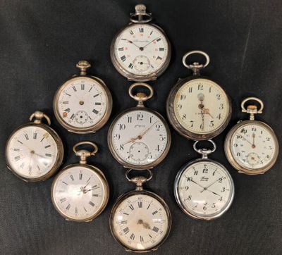 six montres de poche anciennes sont disposées en cercle sur une surface noire