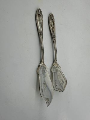 pair of silverware spoons on a white surface
