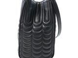 the small black bag is on a white surface