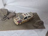 a toy car that is sitting on top of a piece of paper