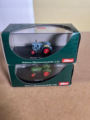 a box with a toy tractor in it on a table