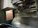 an image of a machine that is working on a piece of metal