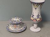 a small vase and a small plate on a table