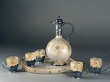 an image of a glass and metal pitcher with cups on a tray