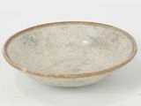 a white bowl with a brown rim sitting on a table