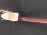 a wooden stick with a piece of wood sticking out of it