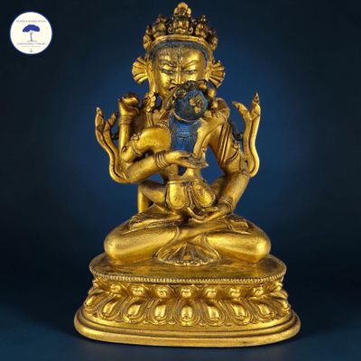 a gold statue of a person sitting on top of a table