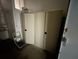 a small room with a ladder in it and a closet