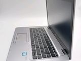 a silver laptop with a blue sticker on the screen