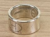 a silver ring that has holes in it on a table