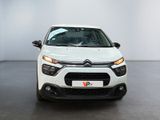 the front view of a white citrole parked in a room