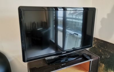 a flat screen tv sitting on a stand in a living room