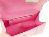 the inside of a pink purse with a silver handle